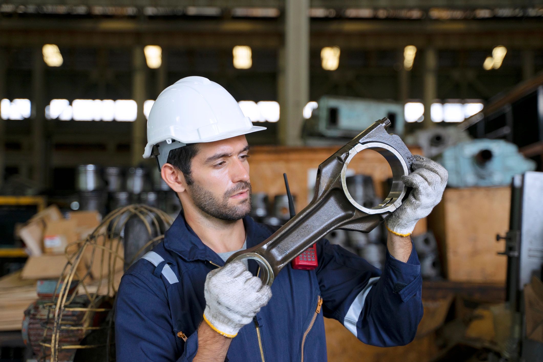 Industrial worker inspecting heavy machinery in a factory environment